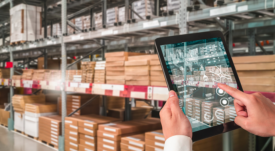 Employee using the new ERP system on an iPad while working in the warehouse
