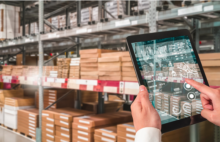 Employee using the new ERP system on an iPad while working in the warehouse