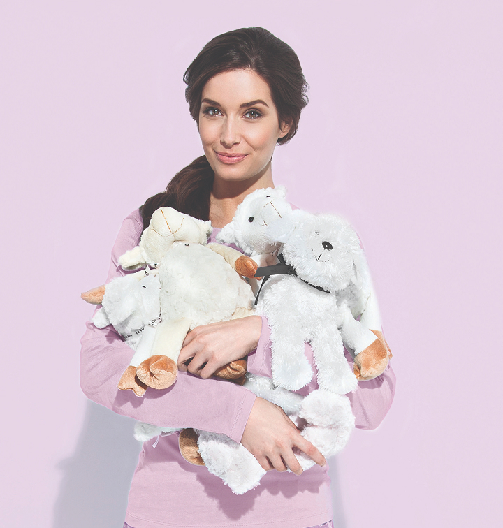 Model holding multiple Roses of Hope plushies