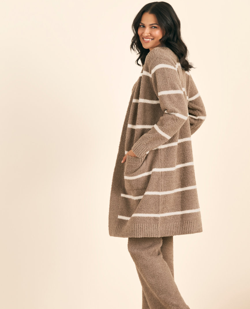 Model in brown lougewear set with white striped cardigan.
