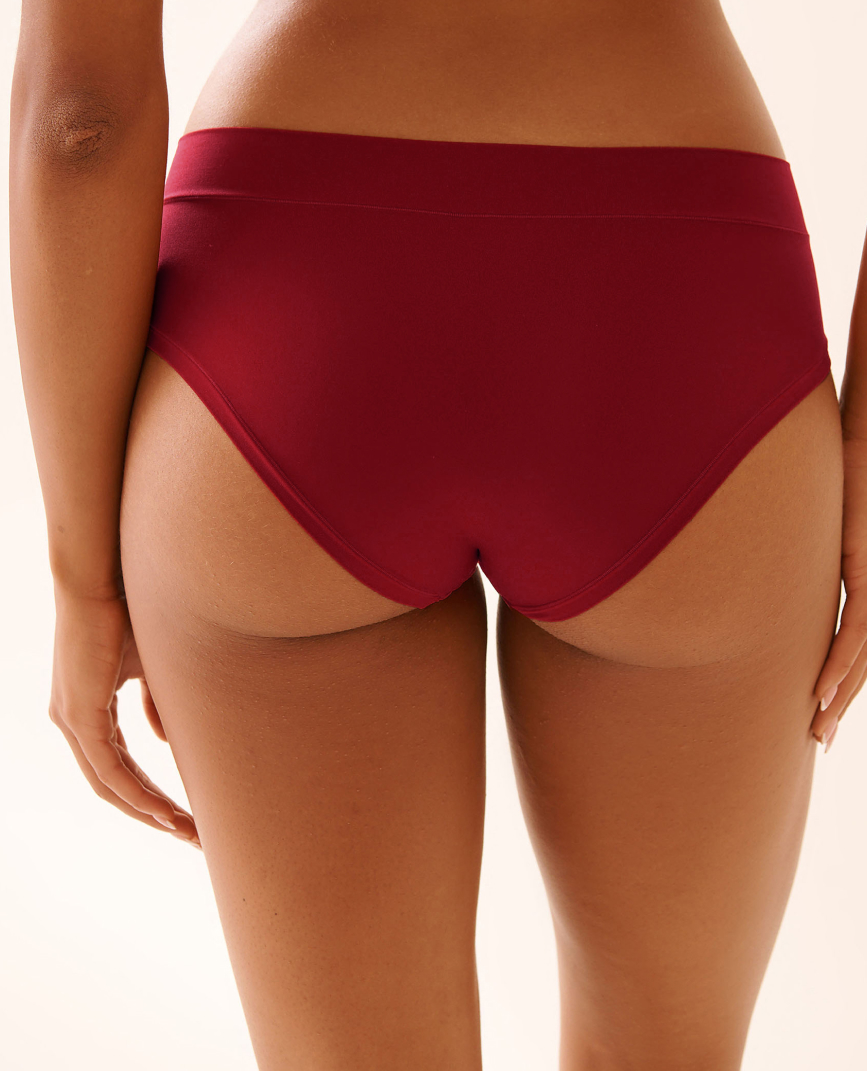 Model shown from the back wearing red panties.