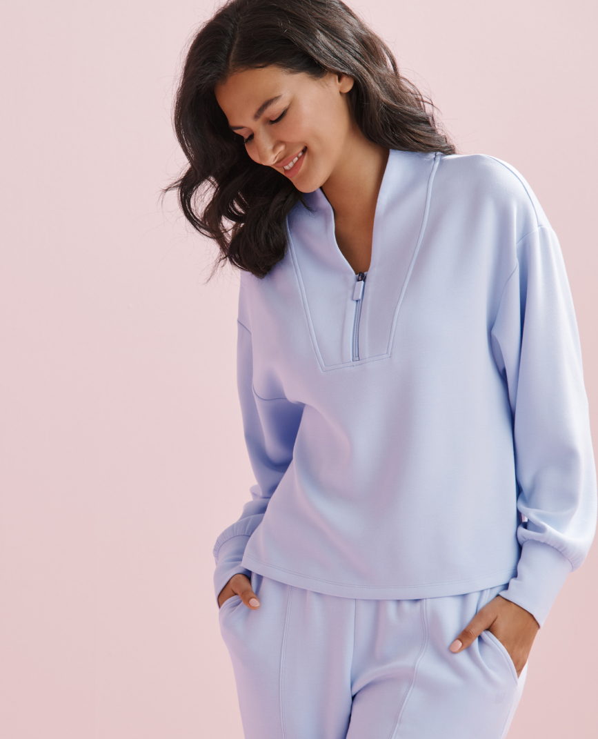 Model wearing a black hoodie from the Body Mind Soul collection.