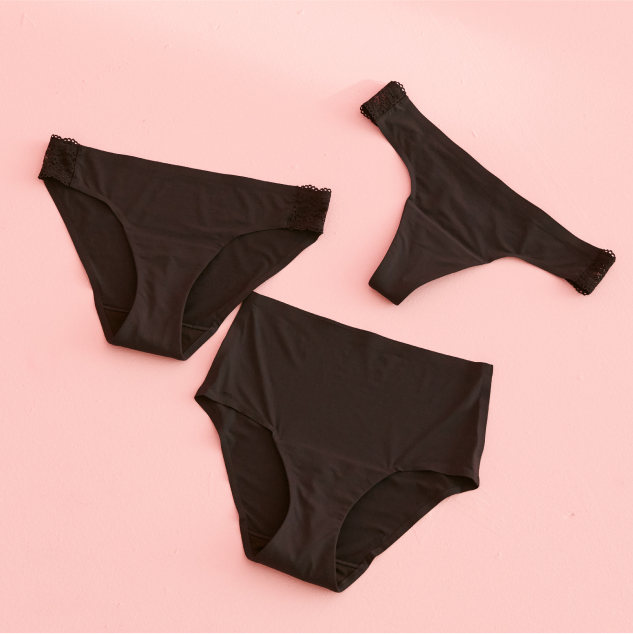 Three black period panties laid out: thong, bikini, and high-waisted