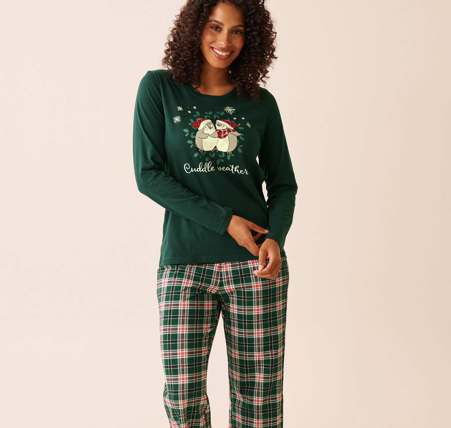 Model wearing a green printed and plaid pajama set in soft cotton fabric.