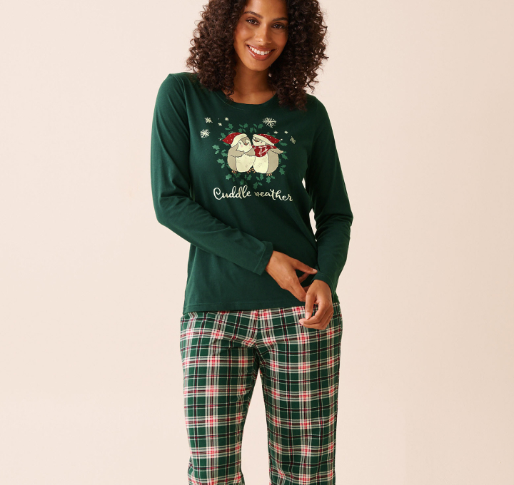 Model wearing a green printed and plaid pajama set in soft cotton fabric.