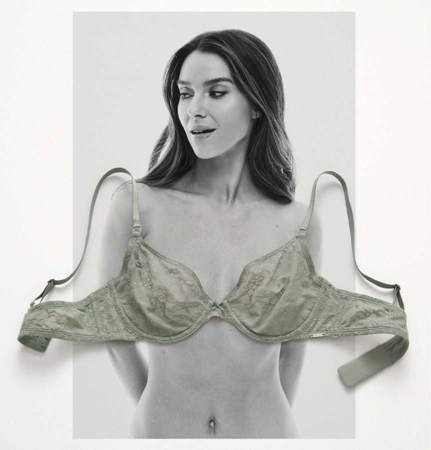 A green lace bra laid on a black-and-white photo of a model
