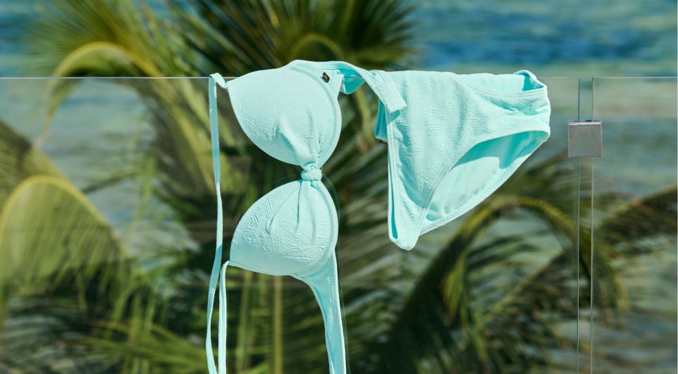 Green bikini swimsuit hanging