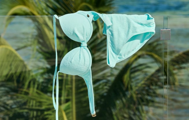 Green bikini swimsuit hanging