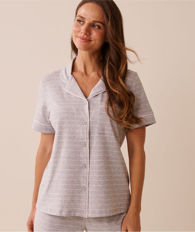 Model wearing a pale pink short-sleeve pajamas top.