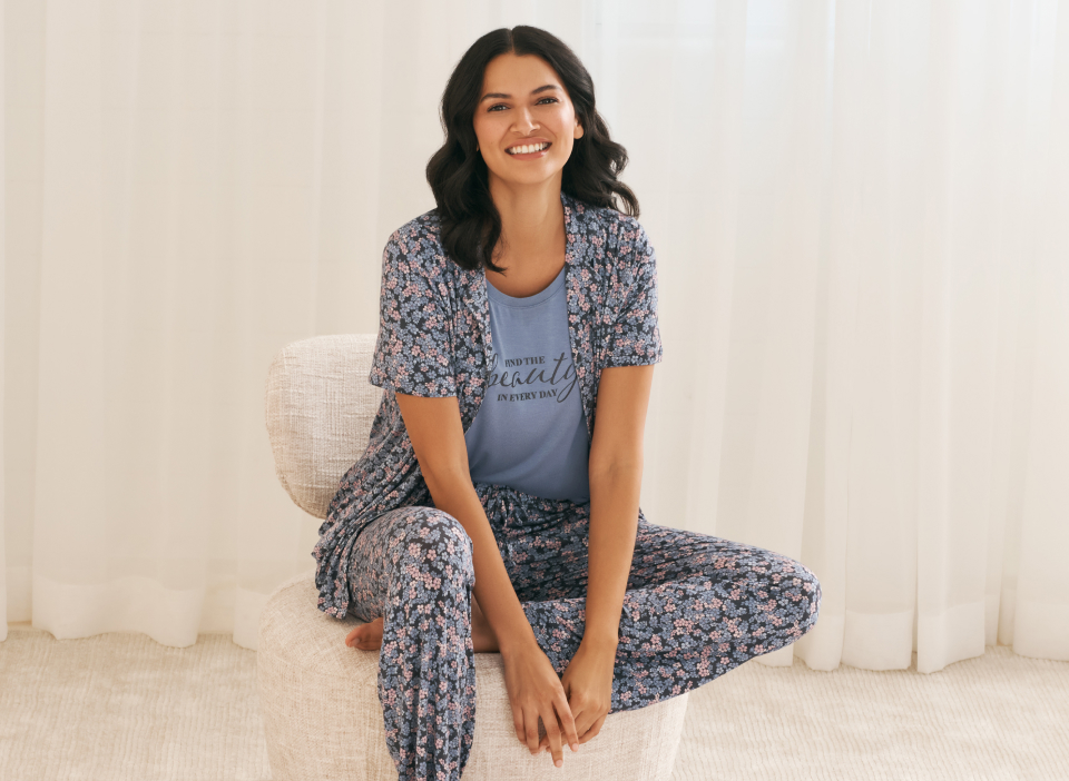 Model in cherry-print pyjamas: short-sleeve top, shorts and pale pink socks.