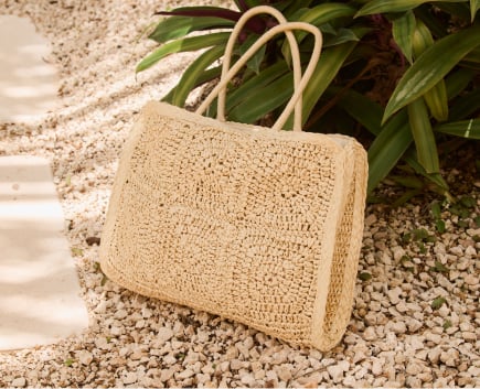 Black straw hat with black bow, seen from behind.