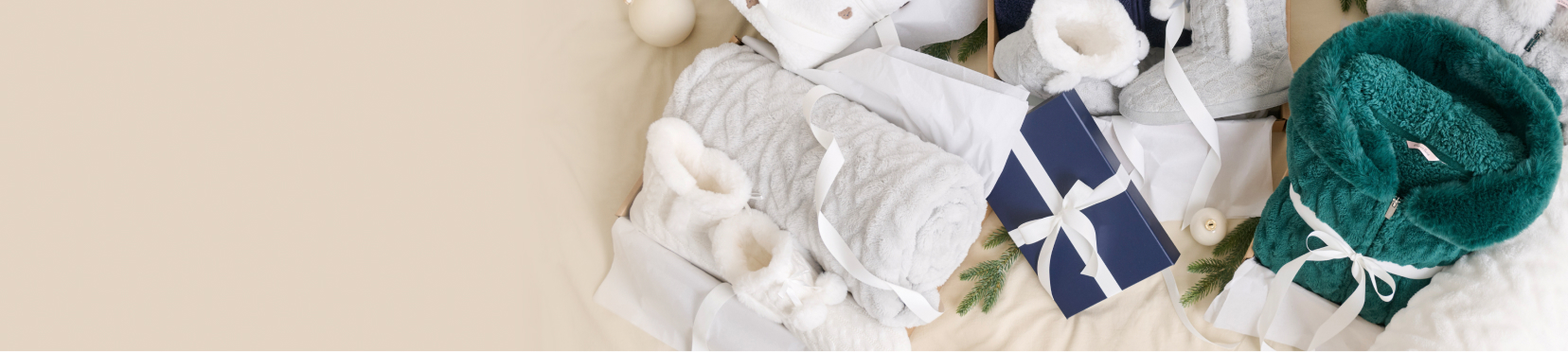 Gift accessories including blankets, slippers and robes neatly wrapped.