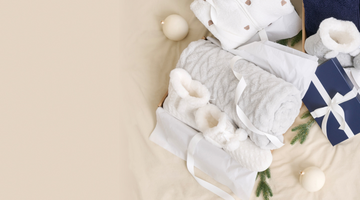 Gift accessories including blankets, slippers and robes neatly wrapped.