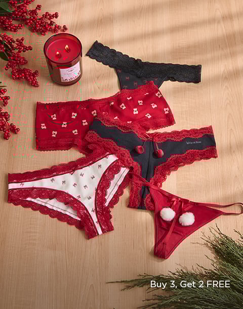 Model wearing a navy lace bra with matching strappy panty